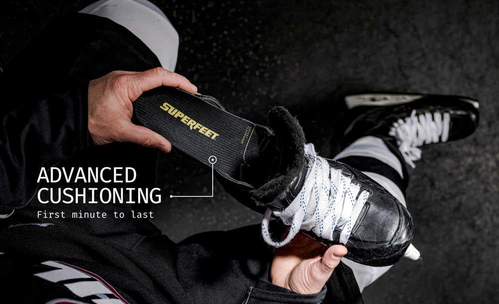 Person putting in Superfeet's Hockey Playmaker Insole into a hockey skate. Text Reads "Advanced Cushioning First minute to last" 
