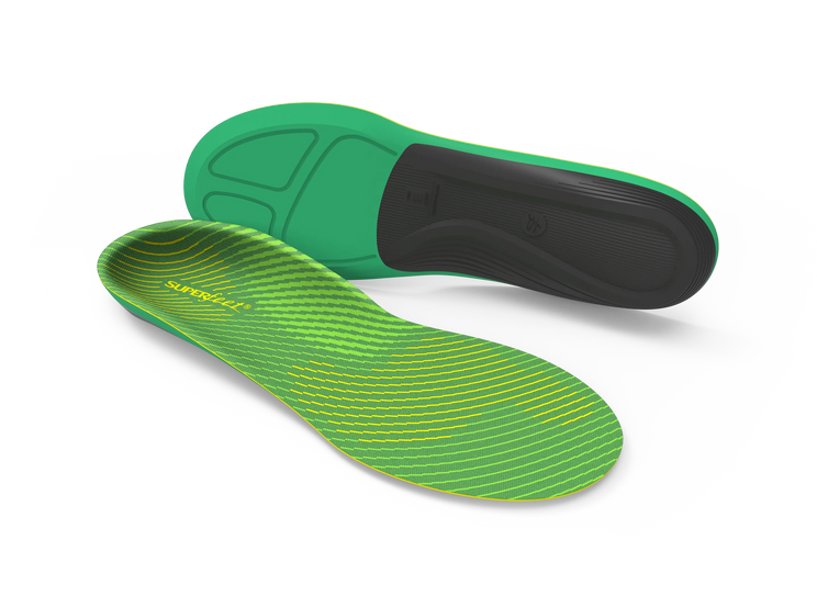 Green and black shoe insoles on a white background